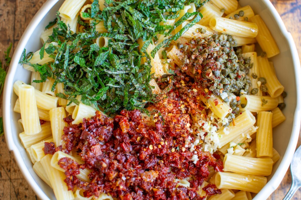 a bowl of pasta topped with sundried tomatoes