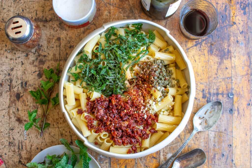 pasta with mint and capers in a white bowl