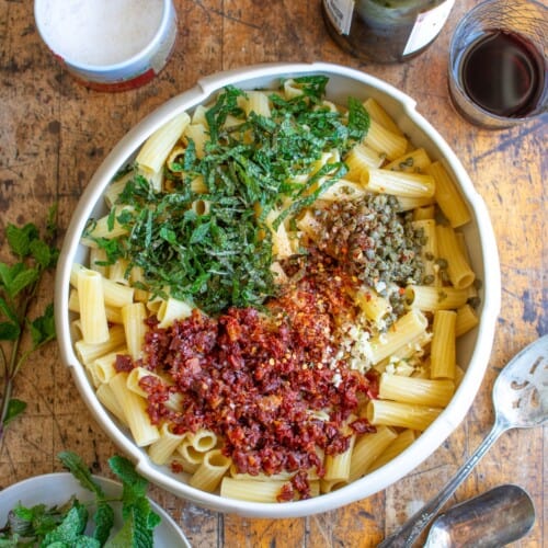 pasta with mint and capers in a white bowl