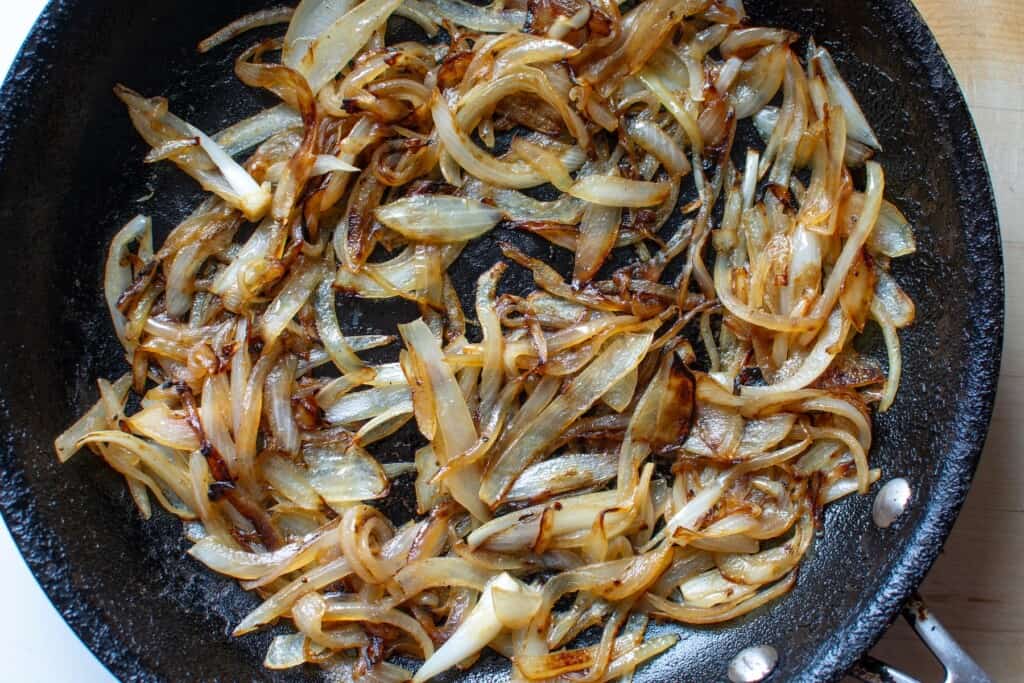 onions caramelized in a black pan