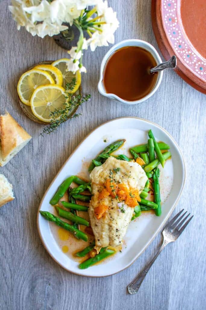 pan seared fish with green beans in a white dish