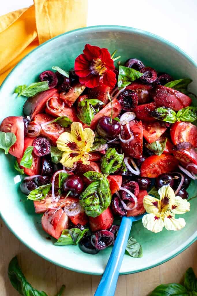 cherry and tomato salad in a green bowl