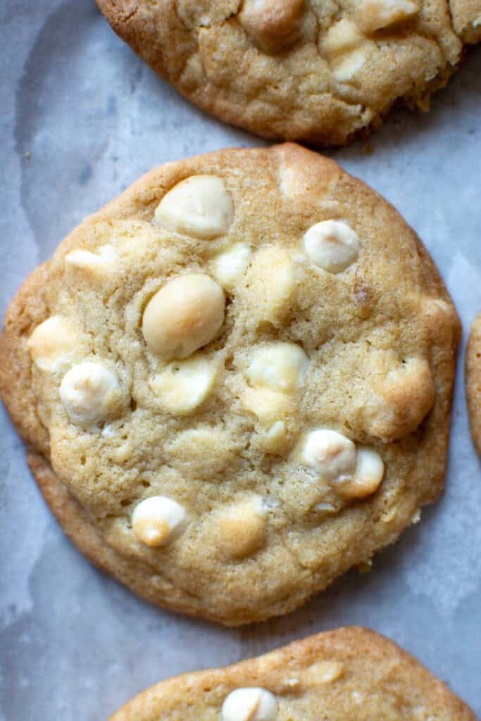 a white chocolate macadamia nut cookie on a baking sheet