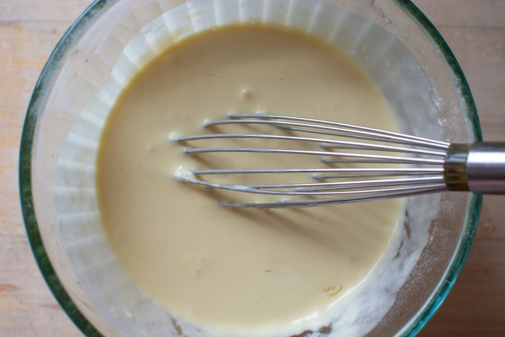 All the wet ingredients in a glass bowl with a whisk