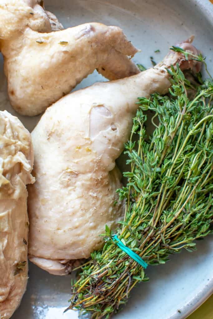 a poached chicken leg on a platter