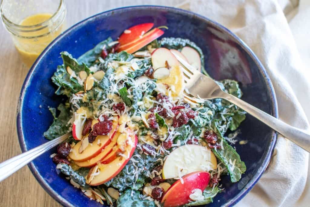 kale salad topped with apples