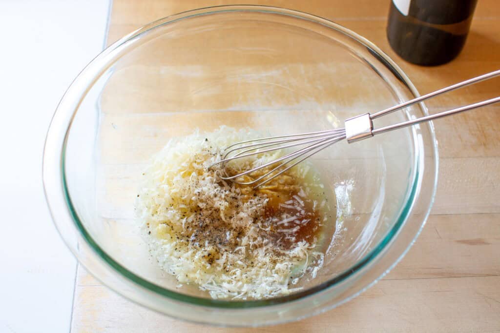 All the ingredients in a glass bowl with a whisk
