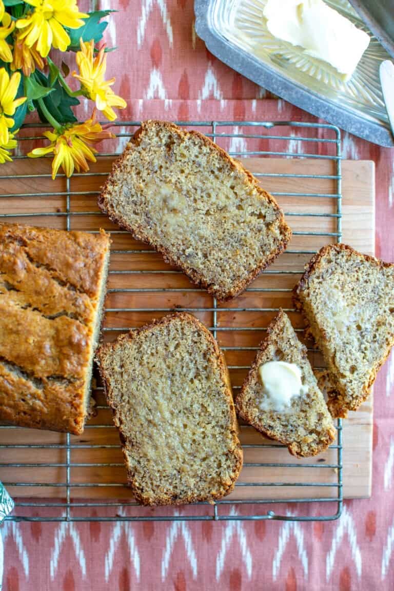banana bread cut into slices with butter