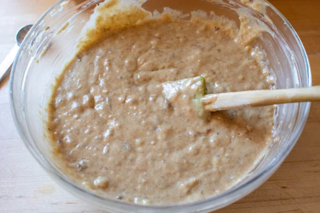 banana bread batter with a spatula in the bowl
