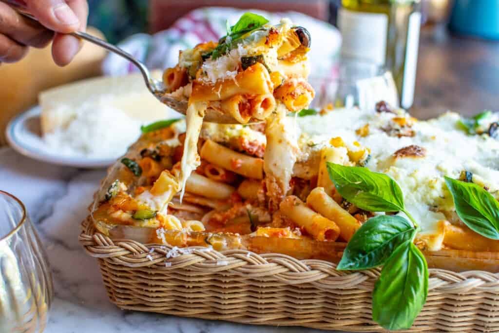 baked ziti being held on a spoon