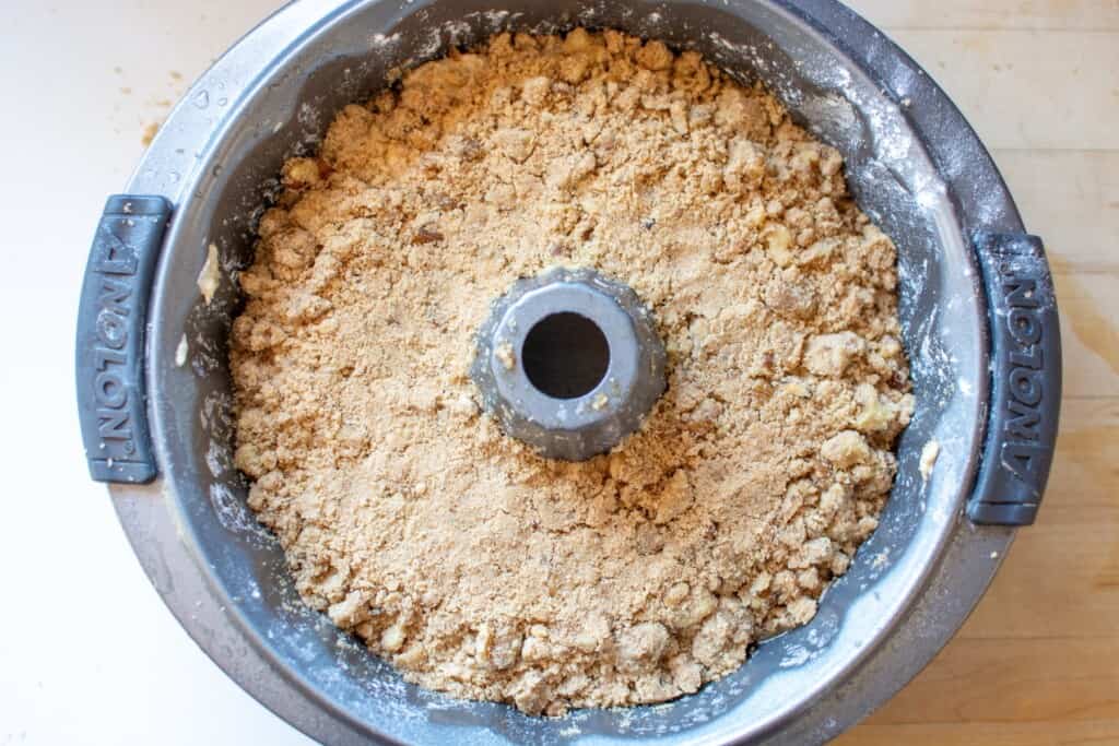 cake being layered in a bundt pan