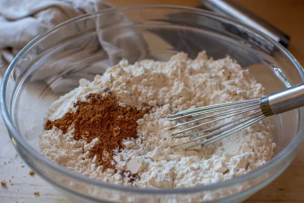 flour in a glass bowl with a whisk