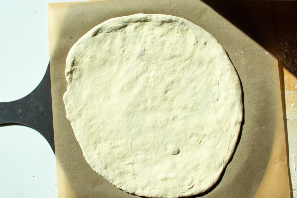 pizza dough on a piece of parchment paper