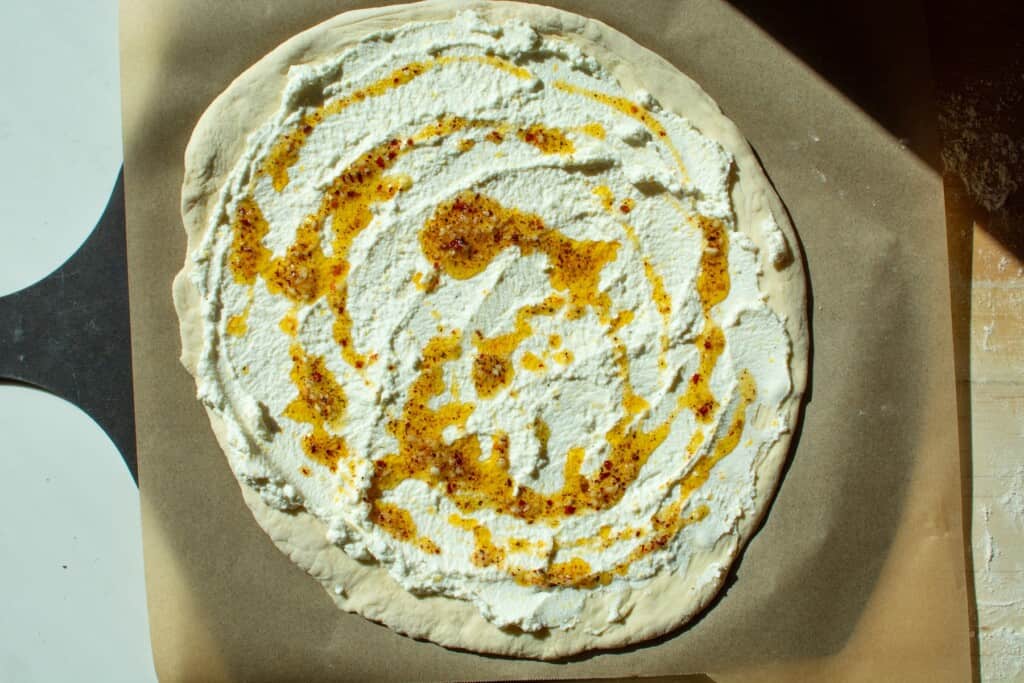 ricotta and garlic oil on top of a pizza