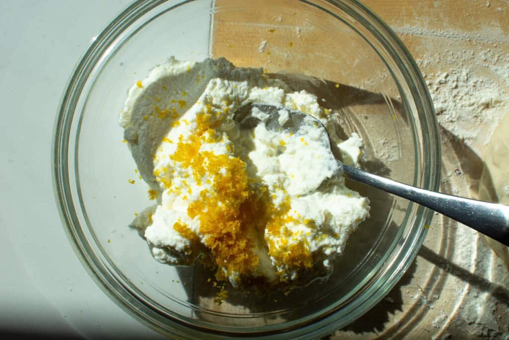 ricotta cheese with lemon zest in a glass bowl