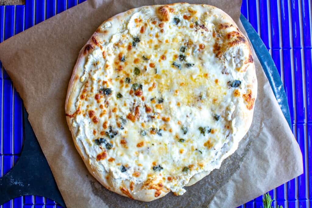 a white pizza after being pulled from the oven