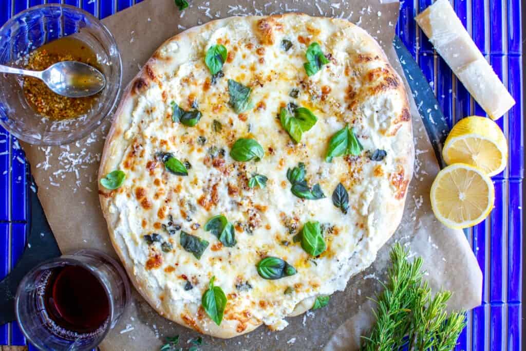 white cheese pizza on a blue tile table
