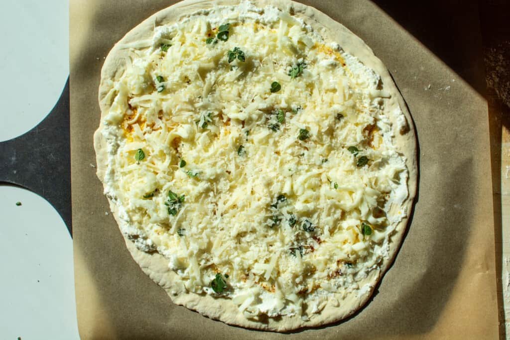 cheese on top of a pizza about to be baked