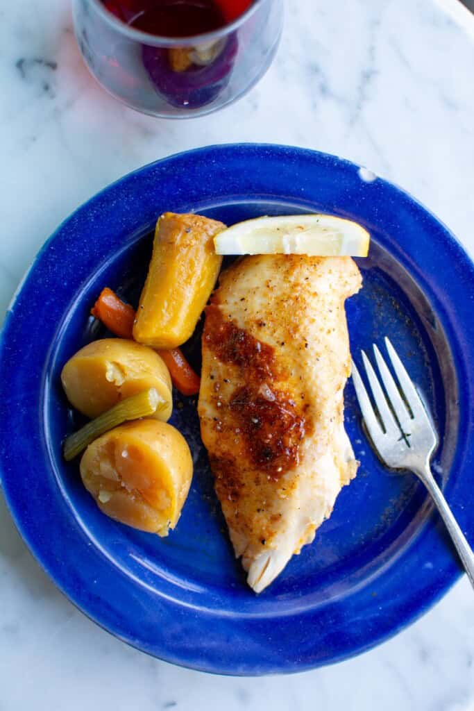 A piece of chicken on a blue plate
