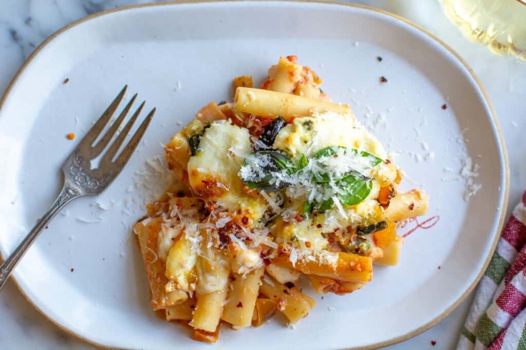 a plate with baked ziti and a fork