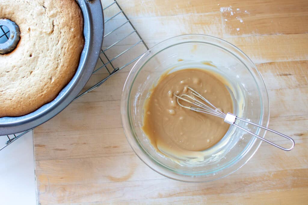 glaze in a bowl with a coffee cake next to it